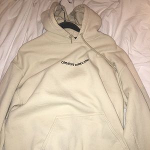 “creative director” cream colored hoodie